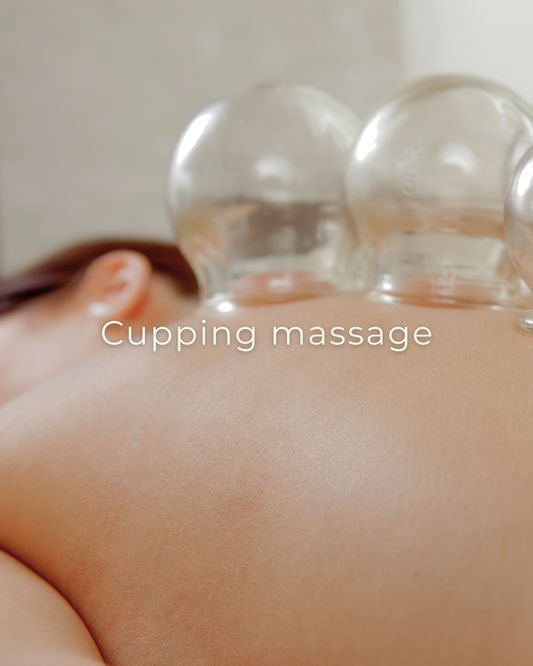 Glazen cups op de blote rug tijdens een Mouram-cuppingmassage.