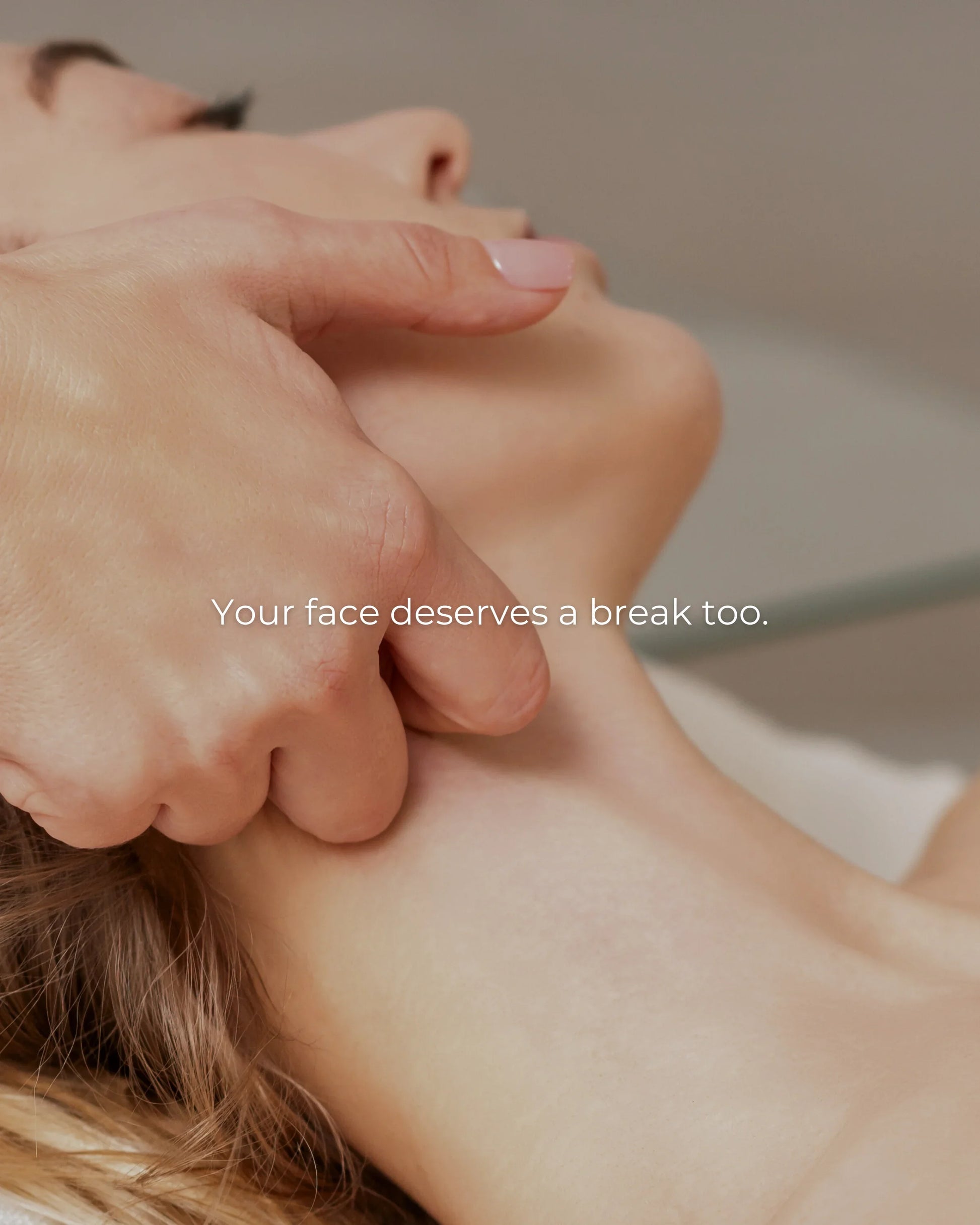 Close-up van een gezichtsmassage met een ontspannende handtechniek op de kaaklijn van een vrouw.